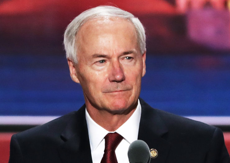 [Photo: Governor Asa Hutchinson looks on during a conference.]