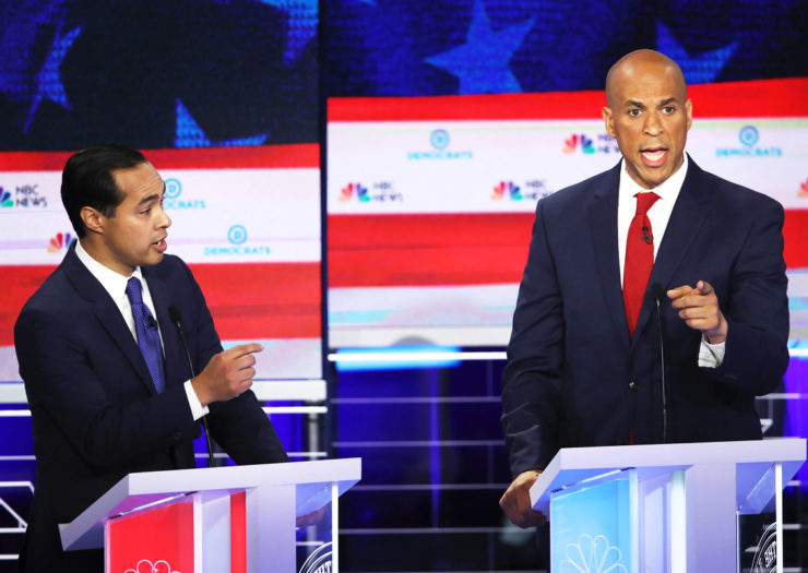 [Photo: Former housing secretary Julian Castro and Senator Cory Booker (D-NJ) take part in the first night of the Democratic presidential debate.]