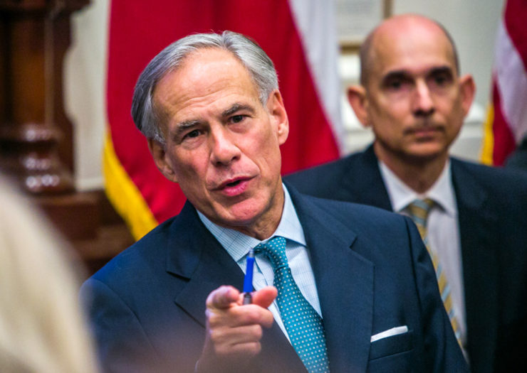[Photo: Texas Governor answers emphatically during a meeting.]