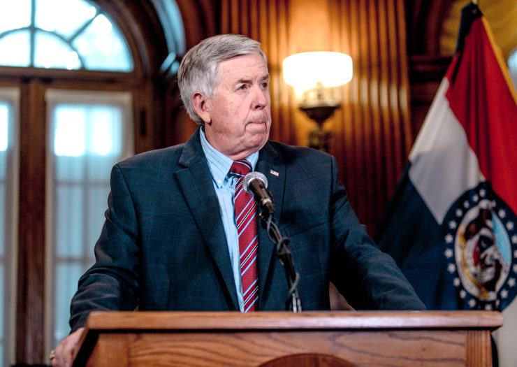[Photo: Missouri Governor Mike Parson listens to a media question during a press conference.]