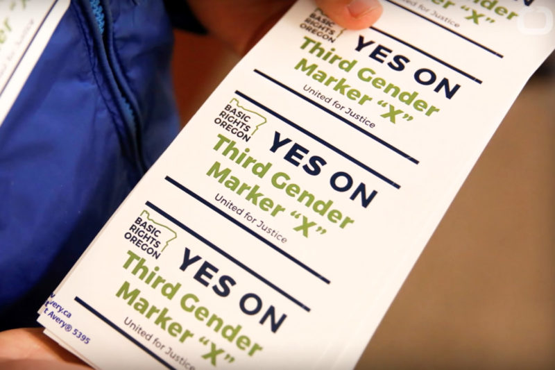 [Photo: A person holding a strip of stickers that read