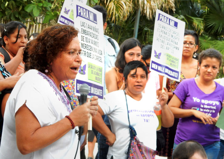 [Photo: A group of Latinx protestors rally in favor of women's rights.]