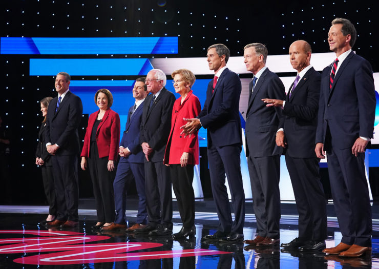 [Photo: Ten of the Democratic presidential hopefuls stand on stage before the beginning of the Democratic debate.]