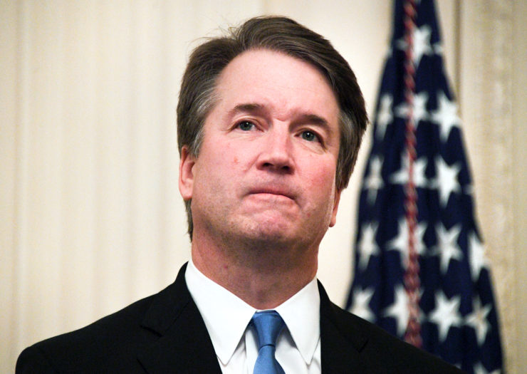 [Photo: Justice Brett Kavanaugh dons a worried look as he listens on during a hearing.]