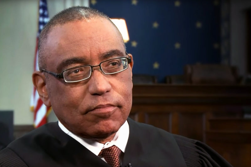 [Photo: U.S. District Court Judge Myron Thompson pauses during an interview.]