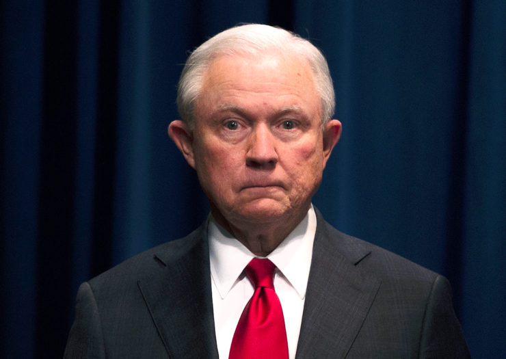 [Photo: Jeff Sessions looks on during an event.]