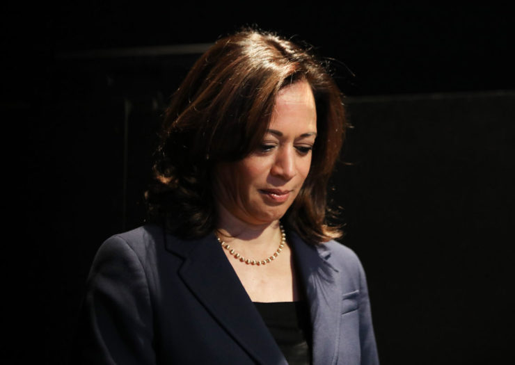 [Photo: Sen. Kamala Harris bows her head as she pauses during an event.]