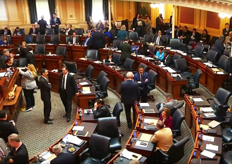 [Photo: Virginia legislators congregate before a legislative session.]