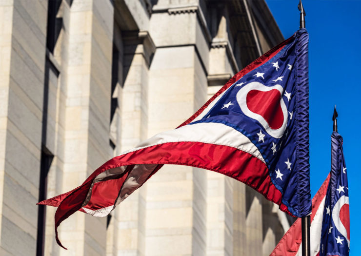 [Photo: Flags fluttering outside of Ohio's Statehouse.]