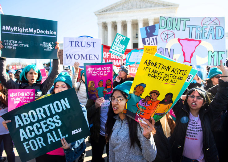 [Photo: Pro-choice activists supporting legal access to abortion hold signs as they protest during a demonstration outside the US Supreme Court.]