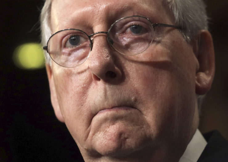 [Photo: Senate Majority Leader Mitch McConnell pauses during a press conference.]