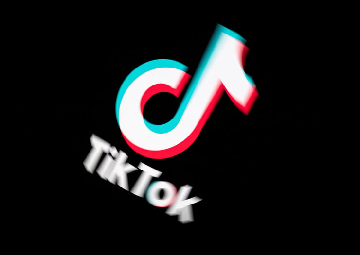 [Photo: An image of a the TikTok logo on a black tablet screen.]
