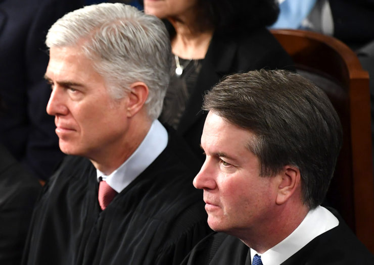[Photo: Supreme Court Justice Brett Kavanaugh and US Supreme Court Justice Neil Gorsuch look on during an hearing.]