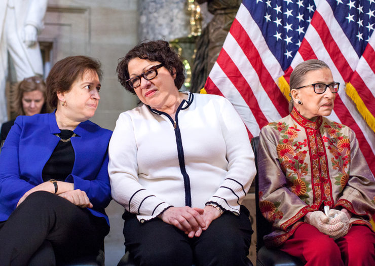 [Photo: U.S. Supreme Court justices Elena Kagan, Sonia Sotomayor and Ruth Bader Ginsburg, sit during an event.]