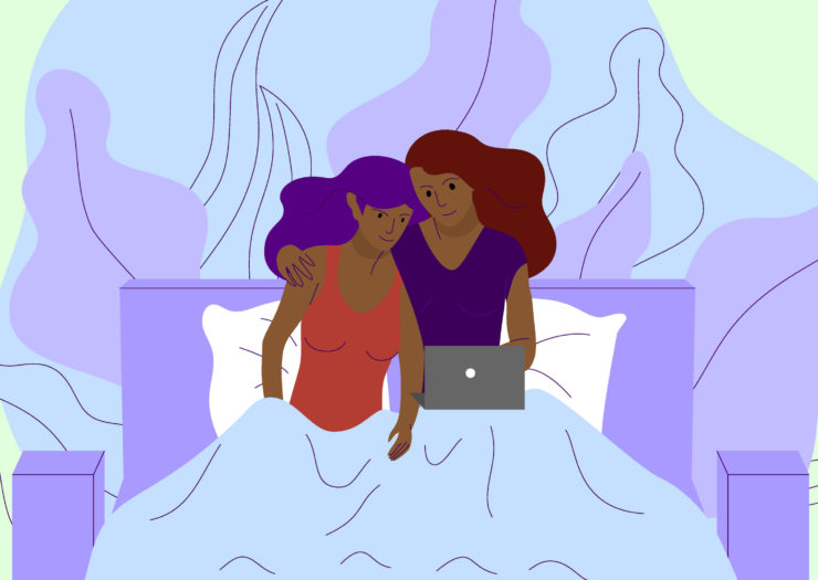 [Photo: An illustration of a queer, femme-presenting couple siting in bed looking at a laptop.]