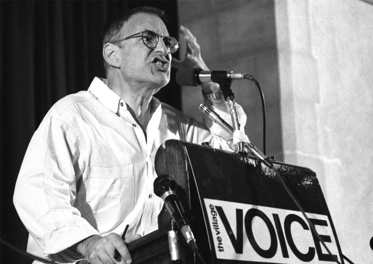 [Photo: A black and white photo of Larry Kramer speaking fervently at the Village Voice AIDS conference on June 6, 1987 in New York City.]