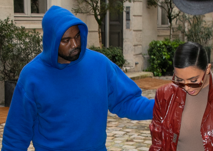 [Kanye West and Kim Kardashian West walking down the street together]