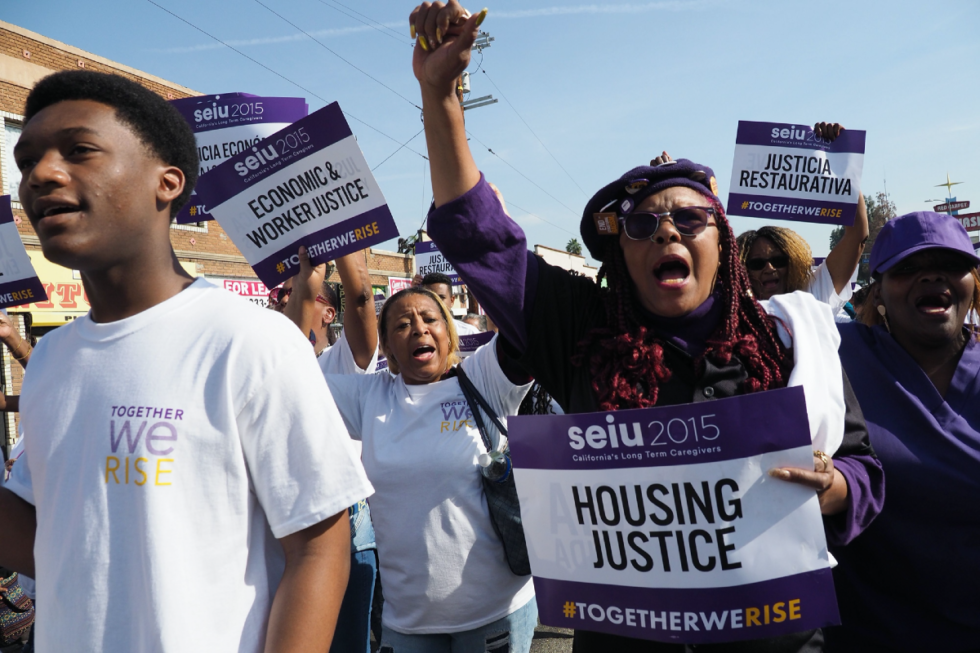 [Protesters marching for housing justice]