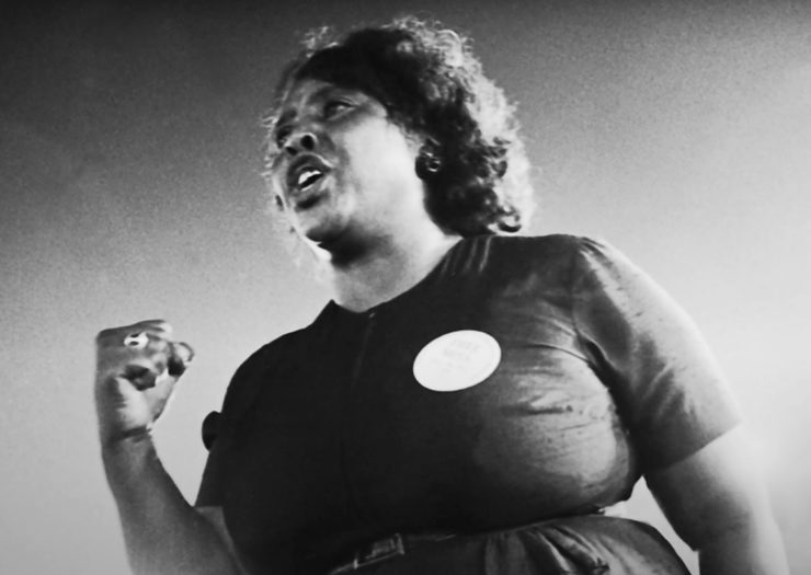 [Photo: A black and white archival photo of Fannie Lou Hamer speaking during an event.]