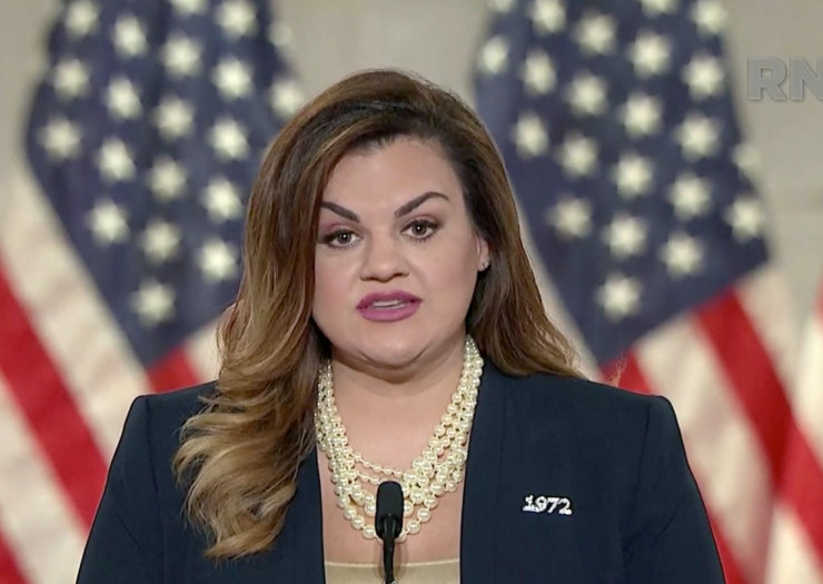 [Photo: Abby Johnson speaks at the Republican National Convention in front of U.S. flags, wearing a pin that says 1972]
