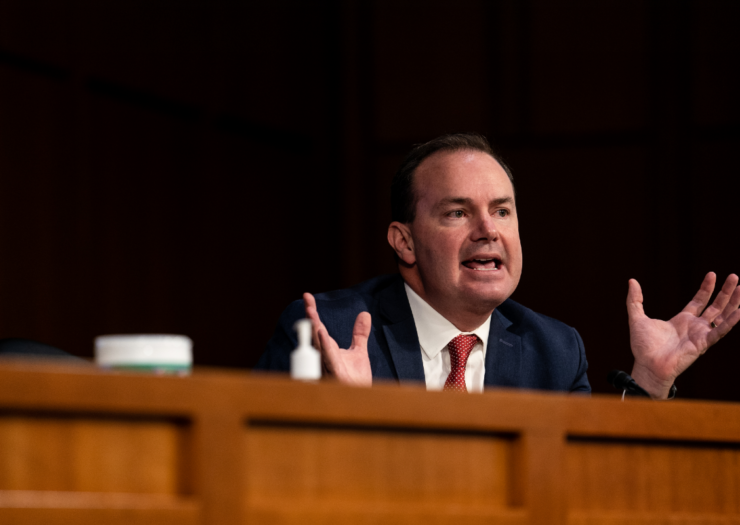 [PHOTO: Mike Lee sitting behind a desk talking during a Senate hearing]