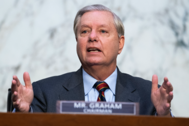 [PHOTO: Lindsey Graham holding his hands out behind a desk]