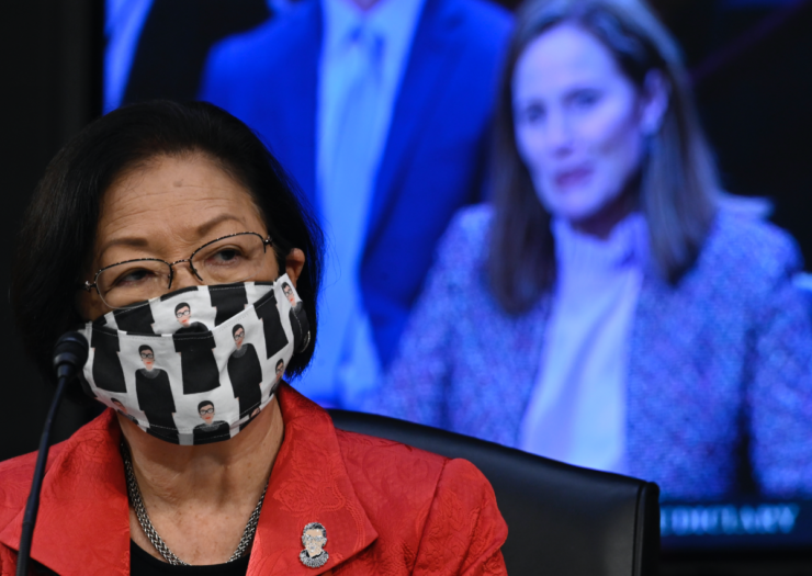 [PHOTO: Mazie Hirono wearing a mask and looking on]