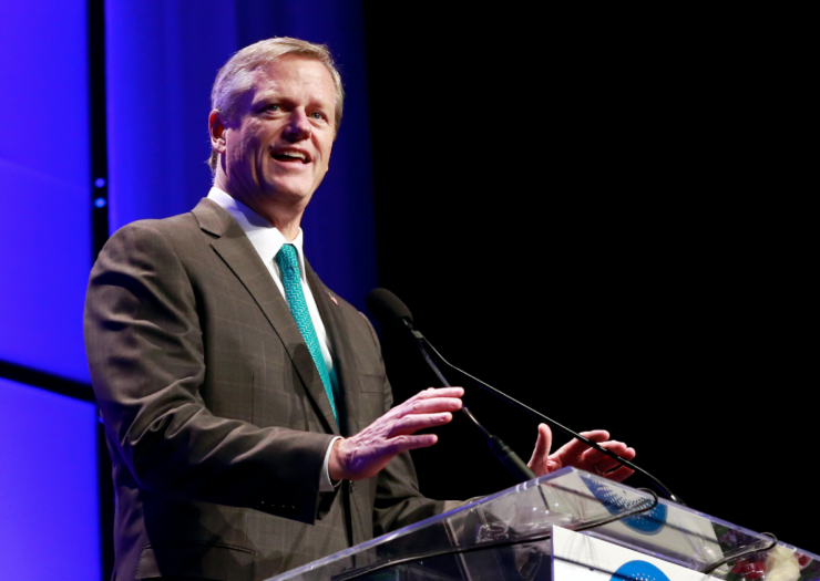 [PHOTO: Gov. Charlie Baker speaking while standing at a podium]