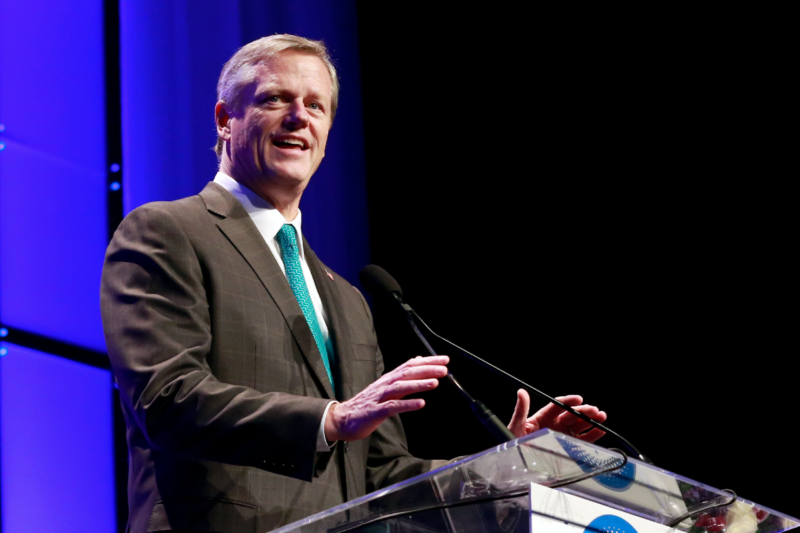 [PHOTO: Gov. Charlie Baker speaking while standing at a podium]