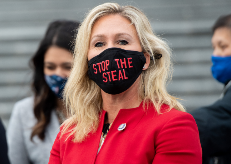 [PHOTO: Woman wearing a face mask that says Stop the Spread]