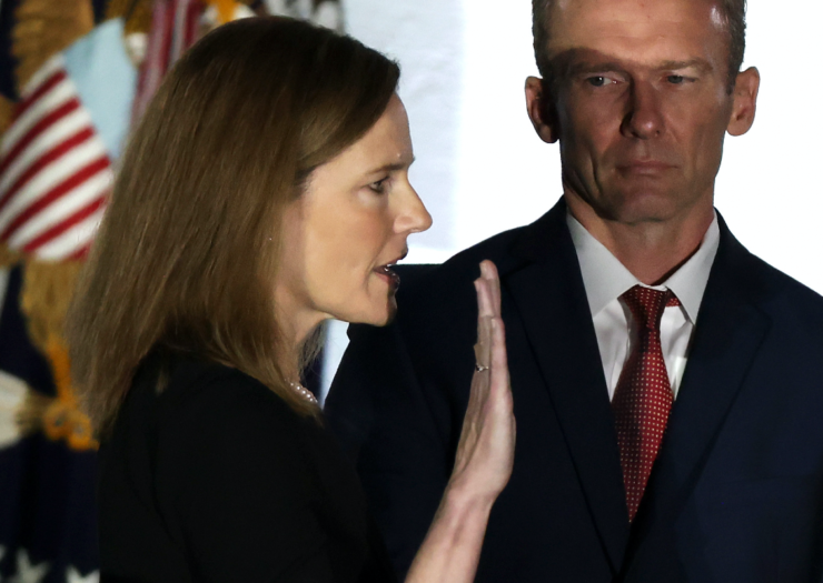 [PHOTO: Amy Coney Barrett facing right with her left hand held up in a pledge]