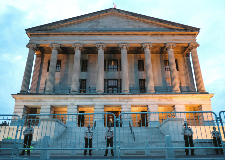 [PHOTO: Tennesse capitol building is a big structure with fencing protecting the front]