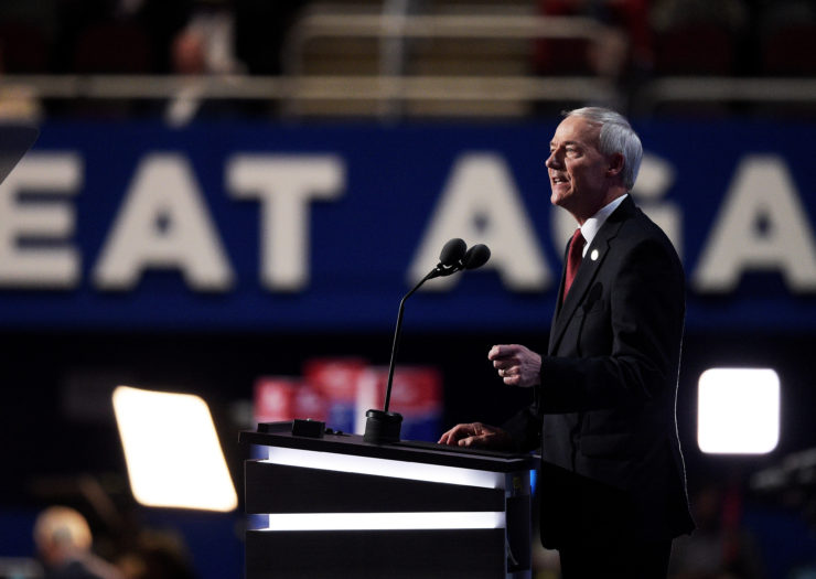 [PHOTO: Asa Hutchinson's side profile as he stands behind a podium and speaks]