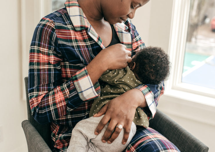Photo of Black woman breastfeeding baby