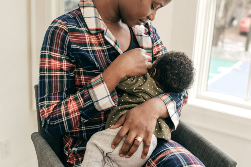 Photo of Black woman breastfeeding baby