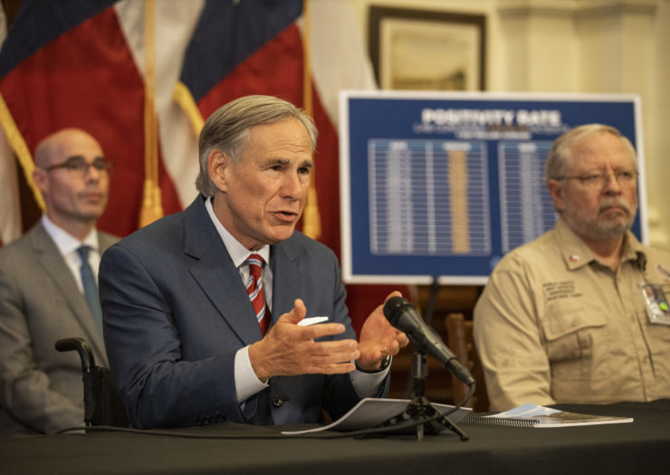 Photo of Texas Gov. Greg Abbott talking behind a desk