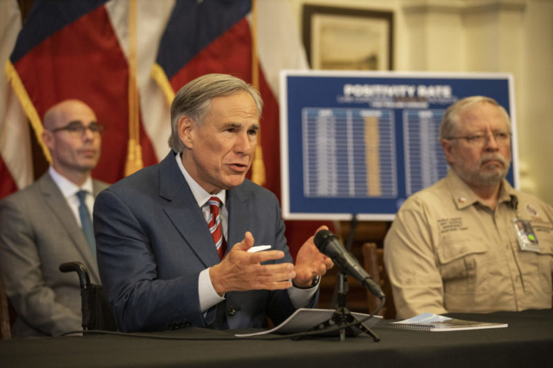 Photo of Texas Gov. Greg Abbott talking behind a desk