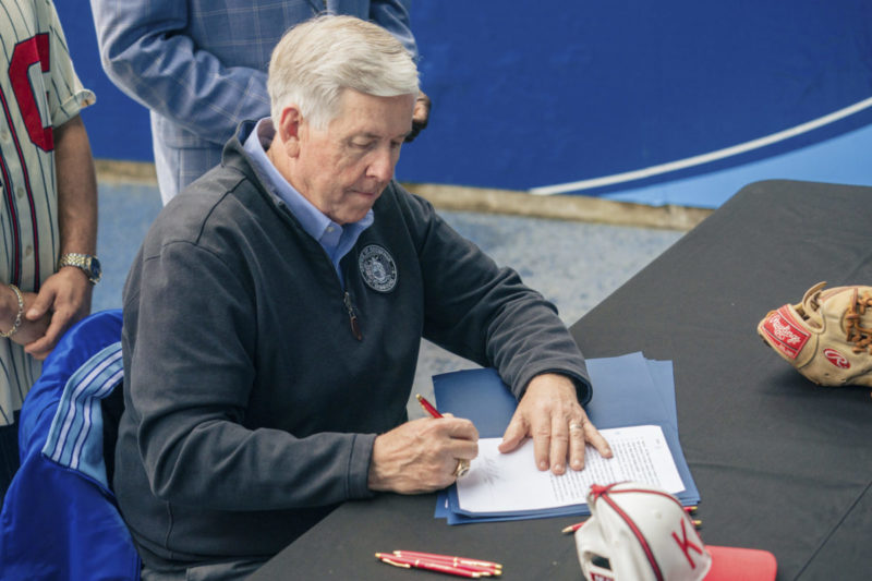 Photo of Missouri Governor Mike Parson signing a bill