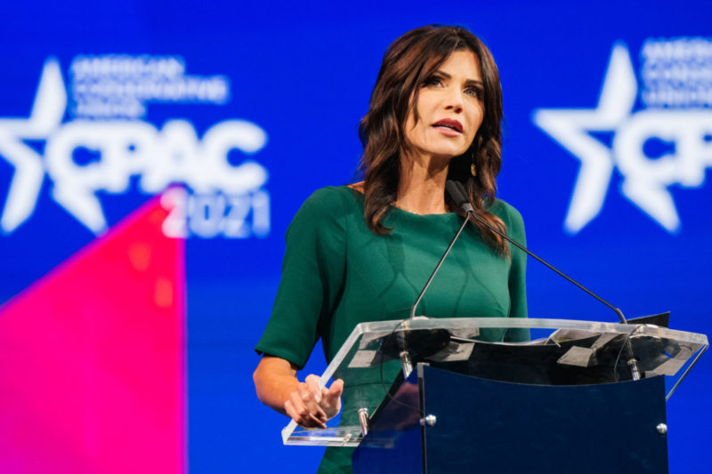 Photo of South Dakota governor Kristi Noem speaking behind a podium at a CPAC conference
