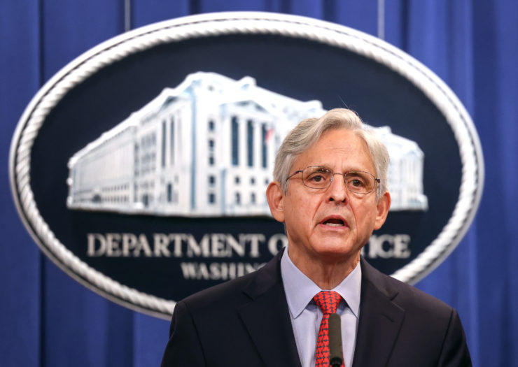 Photo of Attorney General Merrick Garland behind a podium in front of Department of Defense sign