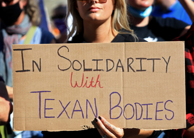 Photo of sign at abortion rally that reads in solidarity with Texan bodies