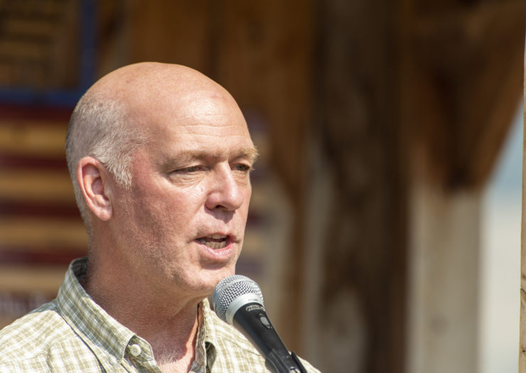 Photo of Montana governor Greg Gianforte speaking in front of a microphone