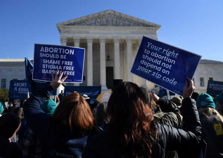 Photo of protesters in front of the Supreme Court holding signs affirming the right to abortion