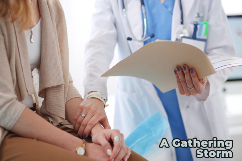 Photo of doctor with hand on patient