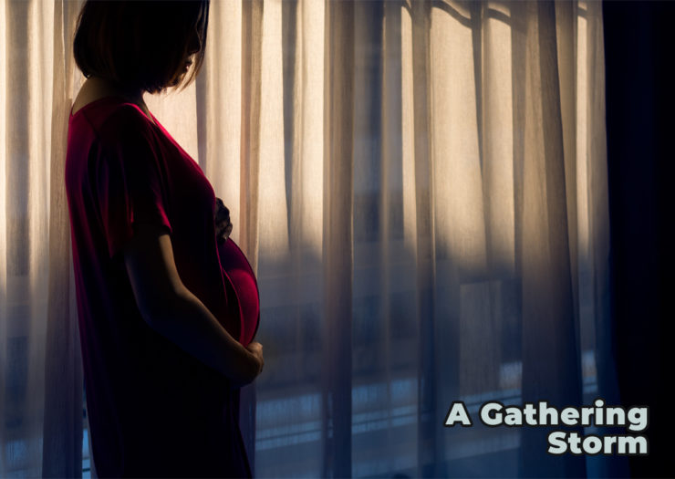 Photo of pregnant woman in the shadows of dimly lit room