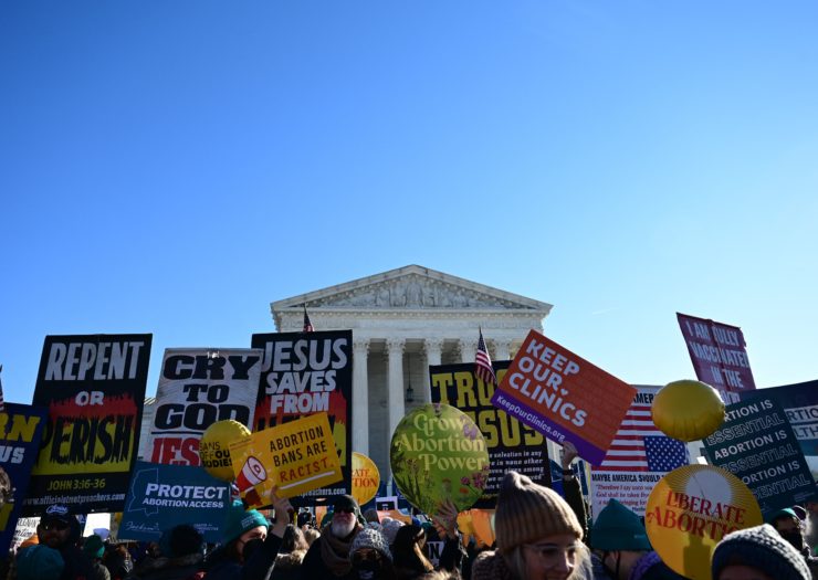 Photo of anti-abortion activists holding signs in front of the Supreme Court