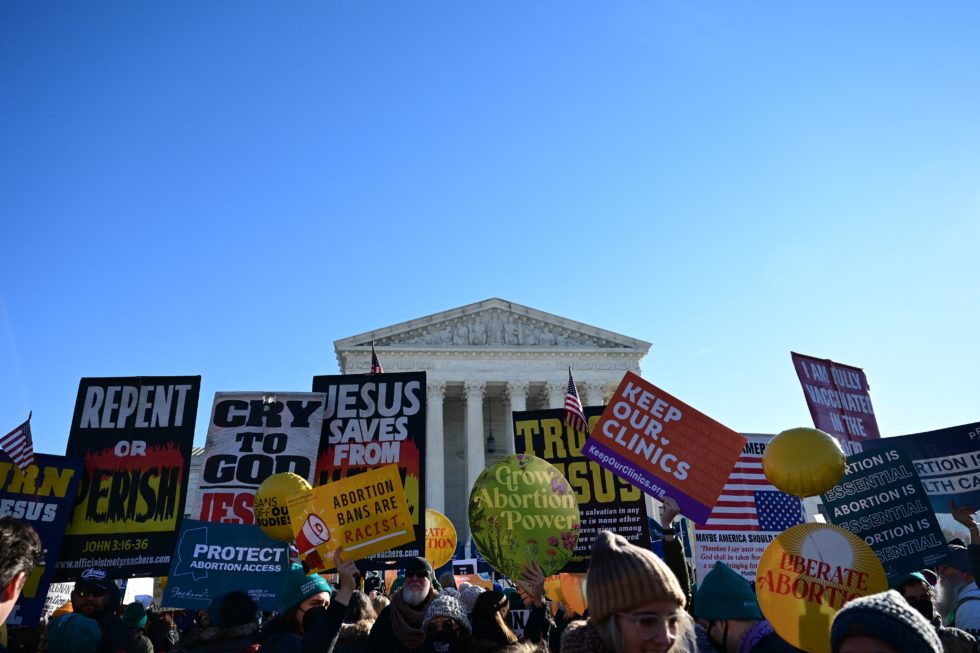 Photo of anti-abortion activists holding signs in front of the Supreme Court