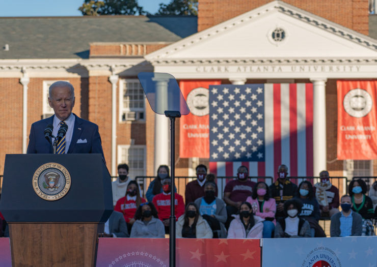 Photo of President Joe Biden behind a podium speaking about voting rights in front of a crowd outside at the Atlanta University Center Consortium