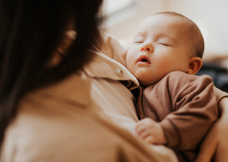Sleeping infant being held