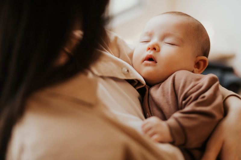 Sleeping infant being held
